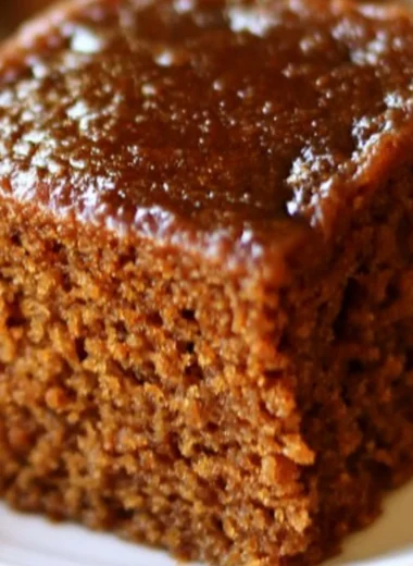 Delicious easy gingerbread cake topped with cream frosting and spices