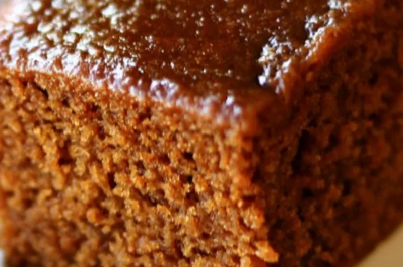 Delicious easy gingerbread cake topped with cream frosting and spices