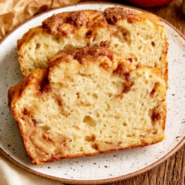 Moist and tender cinnamon apple bread served on a wooden cutting board