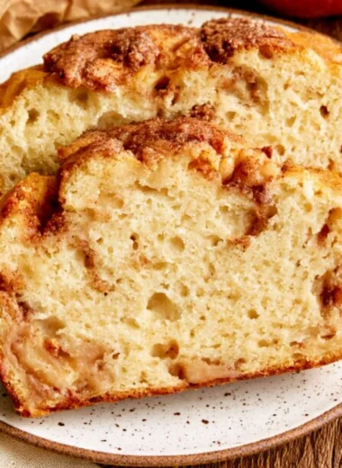 Moist and tender cinnamon apple bread served on a wooden cutting board