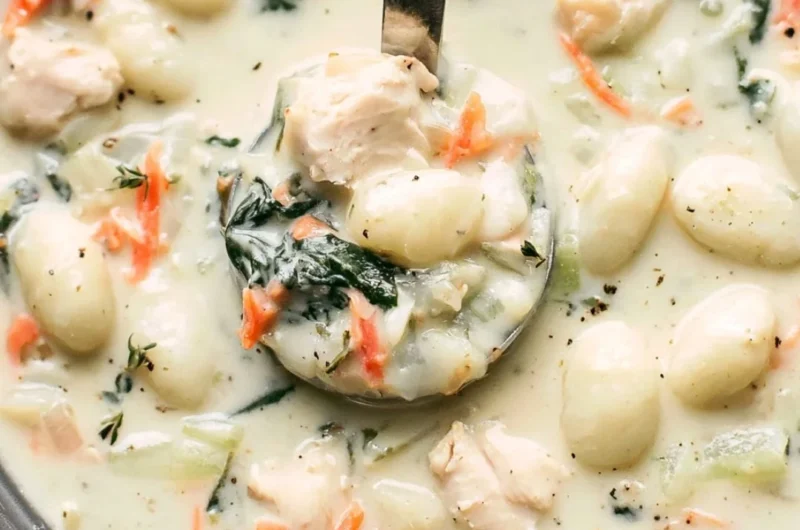 Bowl of Olive Garden Chicken Gnocchi Soup with fresh herbs on top