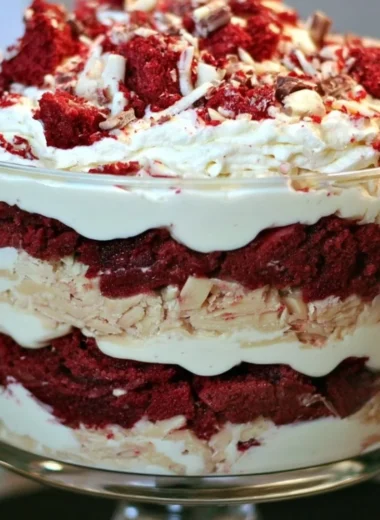 Delicious red velvet trifle layered with cream and cake